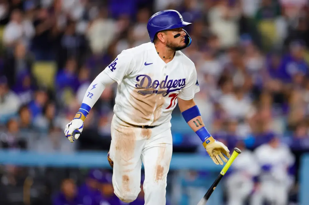 The Dodgers’ Miguel Rojas runs after hitting an RBI single...