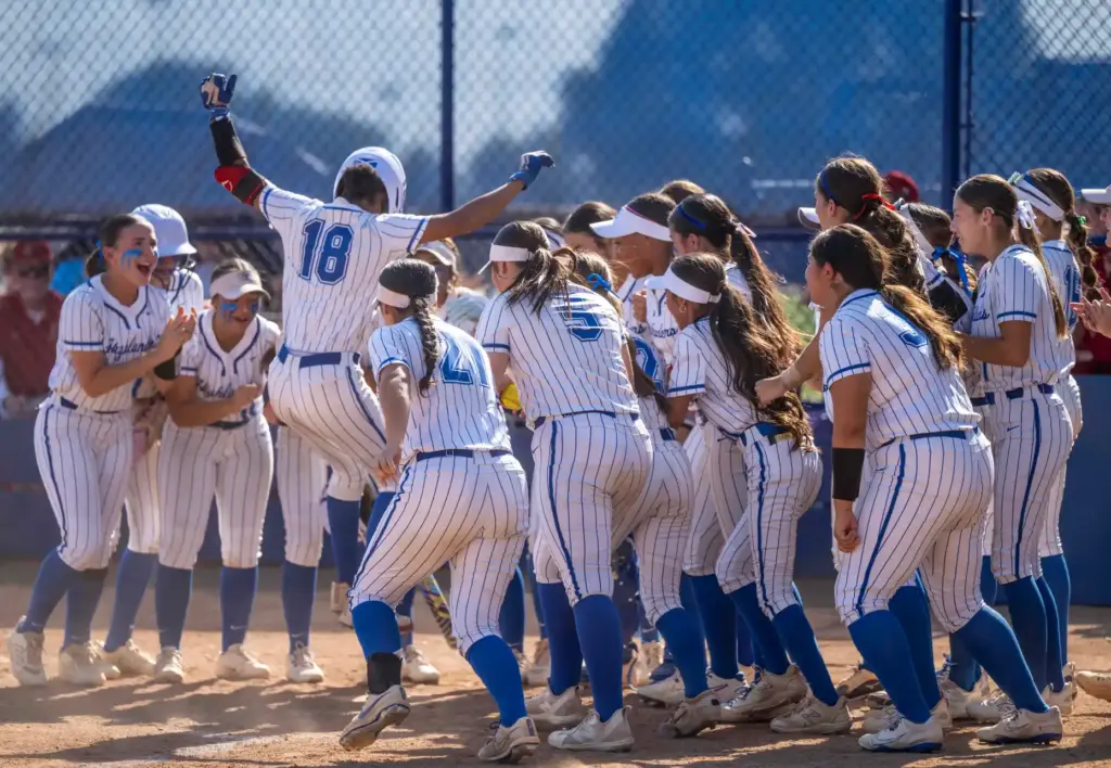 La Habra players celebrate as outfielder Georgia Rickenbacker returns to...
