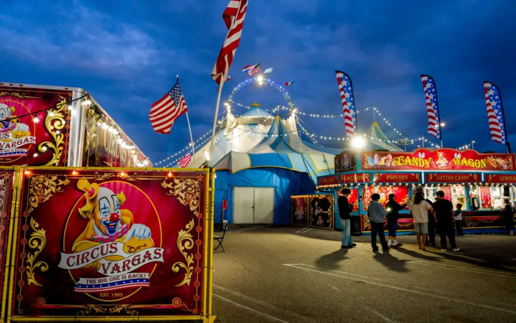 Guests by food outside the Circus Vargas big tent during...