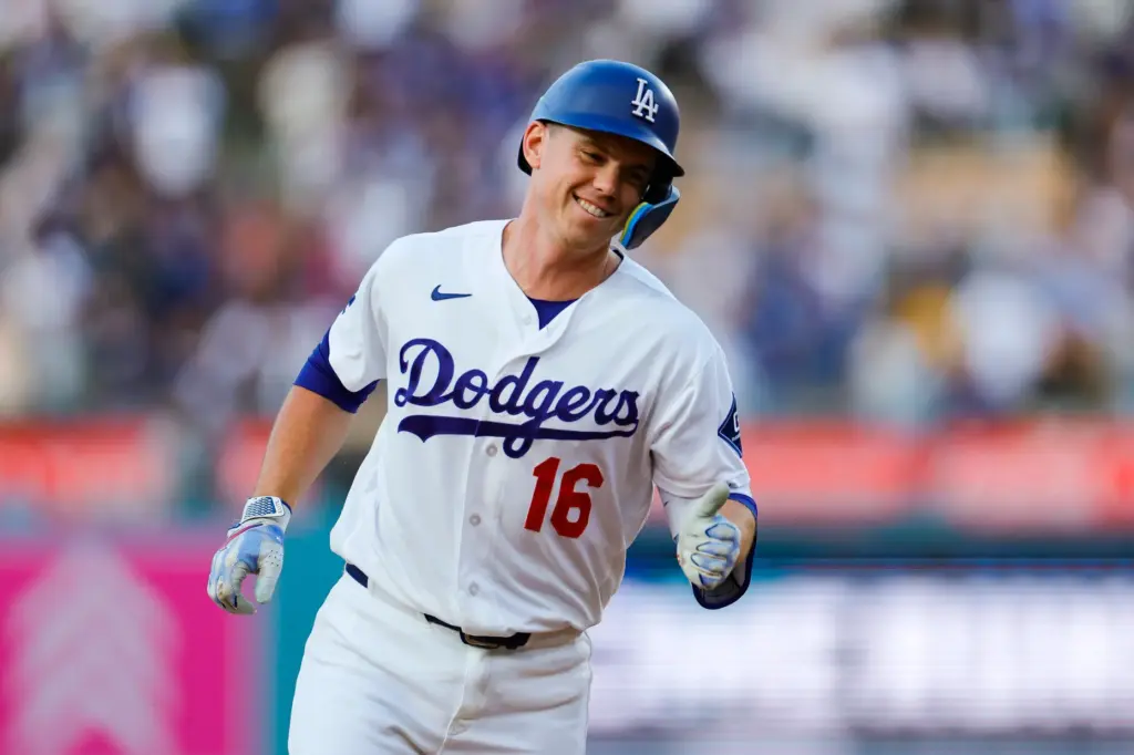 Dodgers designated hitter Will Smith celebrates as he runs the...