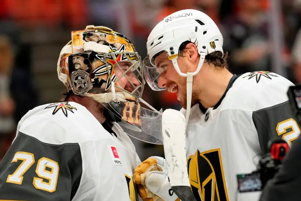 Vegas Golden Knights goaltender Carter Hart, left, and center Brett...
