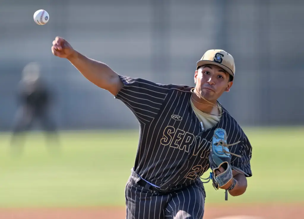 Servite relief pitcher Isaiah Camacho throws to home plate during...