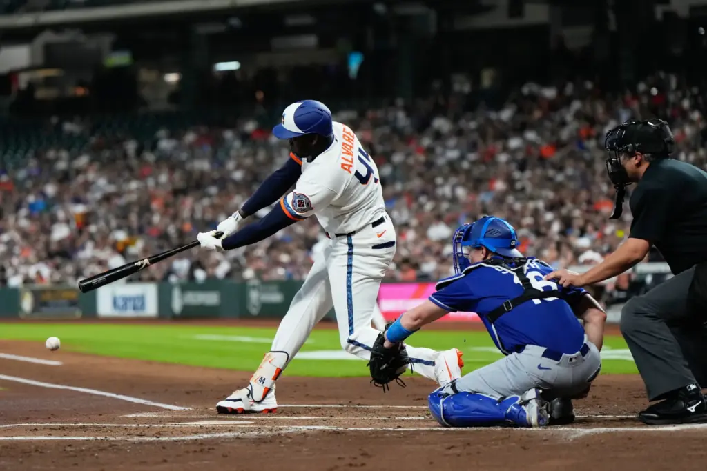 Houston Astros designated hitter Yordan Alvarez hits a single during...