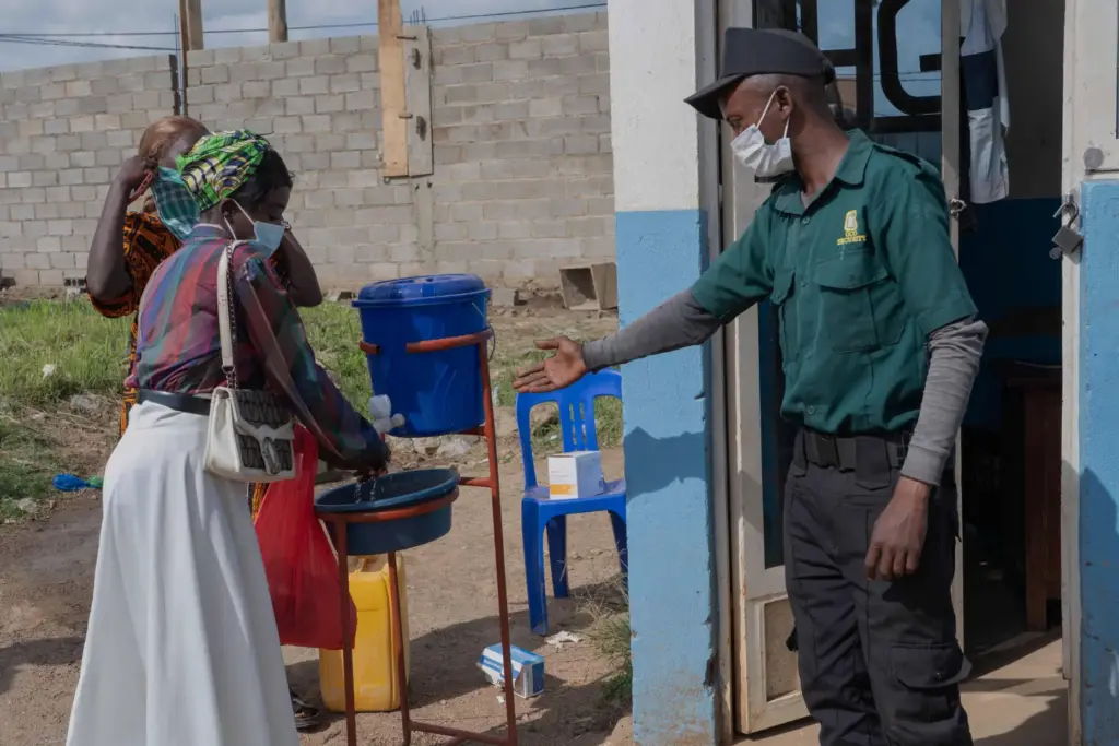 People wash their hands at the entrance to a hospital in Bunia, Congo.