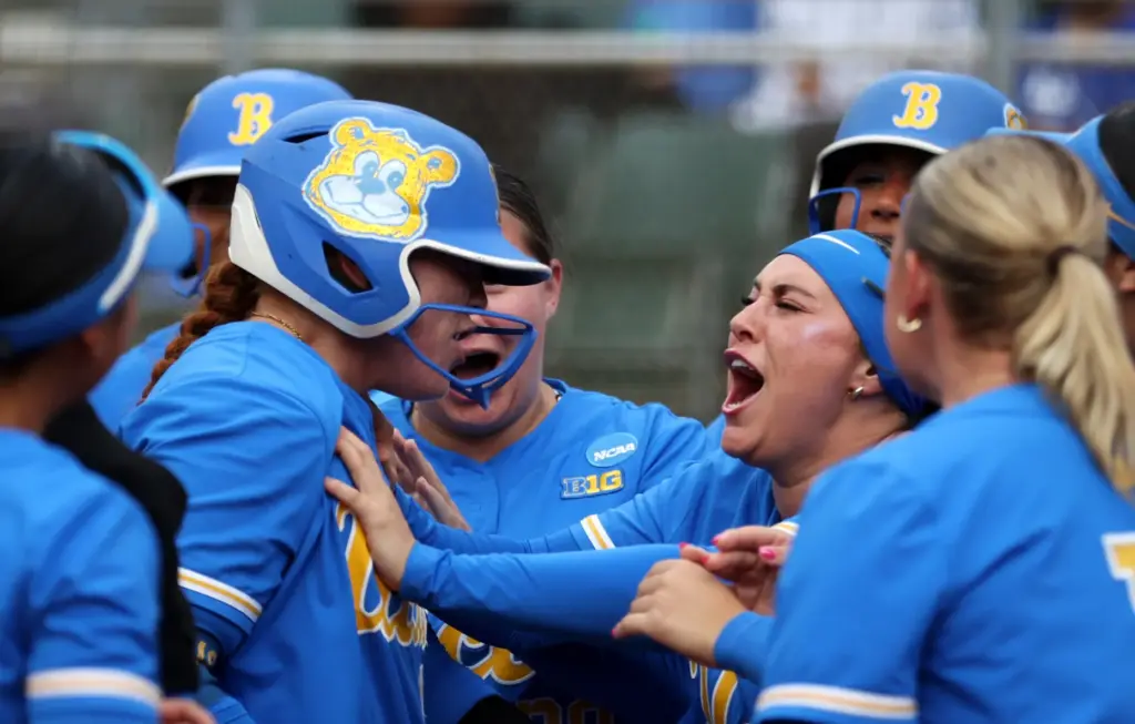 UCLAâs Megan Grant, left, is congragualted by Sofia Mujica, right,...