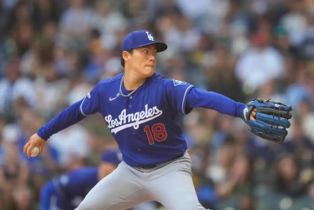 Dodgers starting pitcher Yoshinobu Yamamoto throws to the plate during...