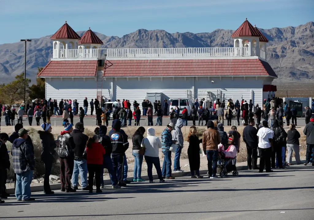 Customers line up to buy Powerball lottery tickets outside the...