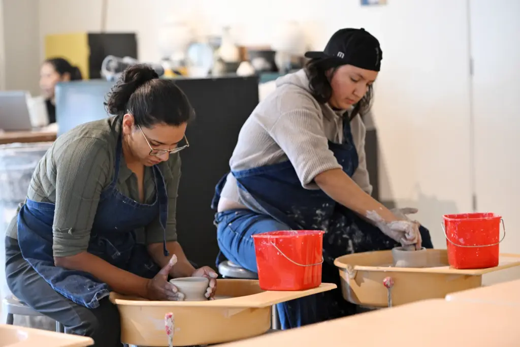Elvira Maravilla and Emma MagaÃ±a of Fullerton work on Art...