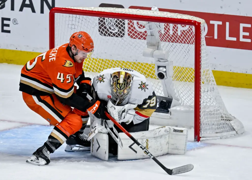 The Ducksâ Beckett Sennecke, left, takes a shot on goal...
