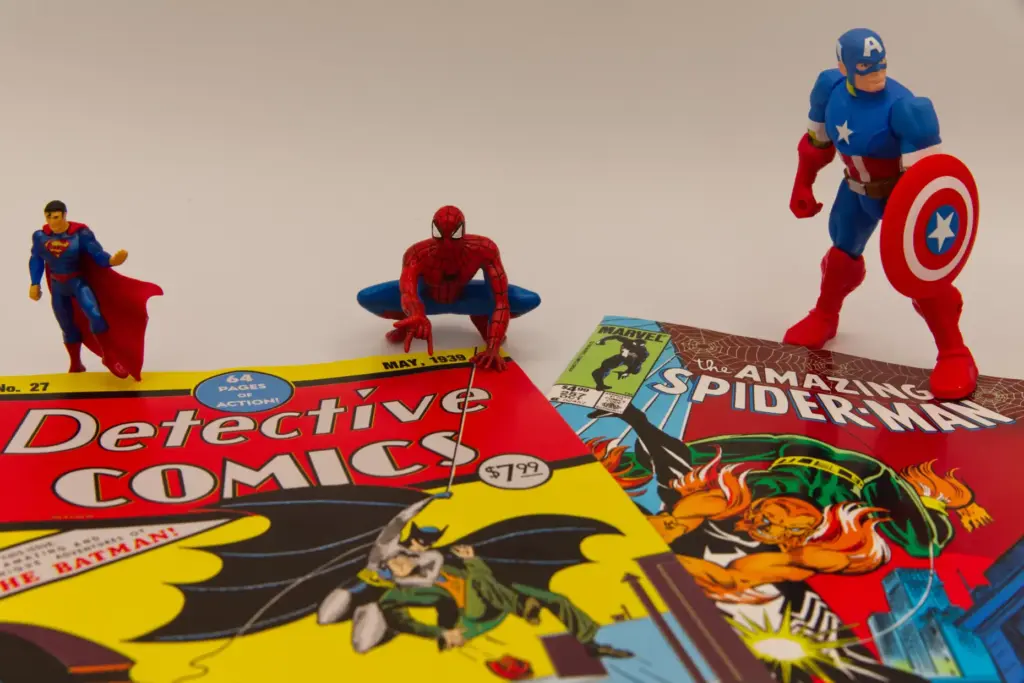 Famous comic book superhero figurines stand next to facsimile copies...