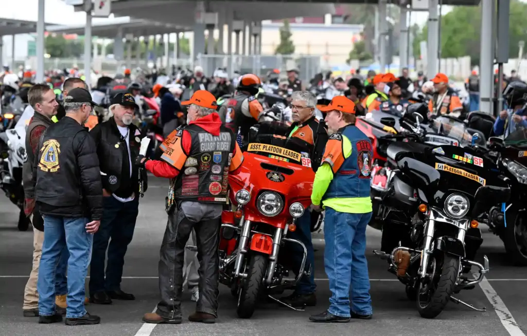 Some of the nearly 900 motorcycle riding participants gather in...