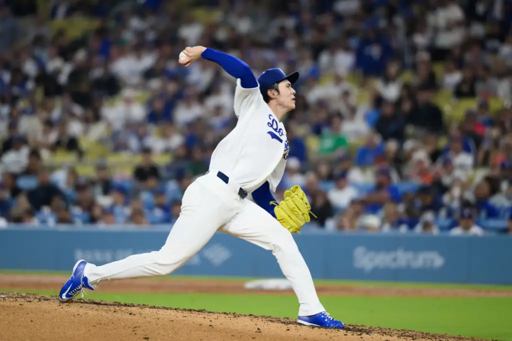 Dodgers starting pitcher Roki Sasaki throws to the plate during...