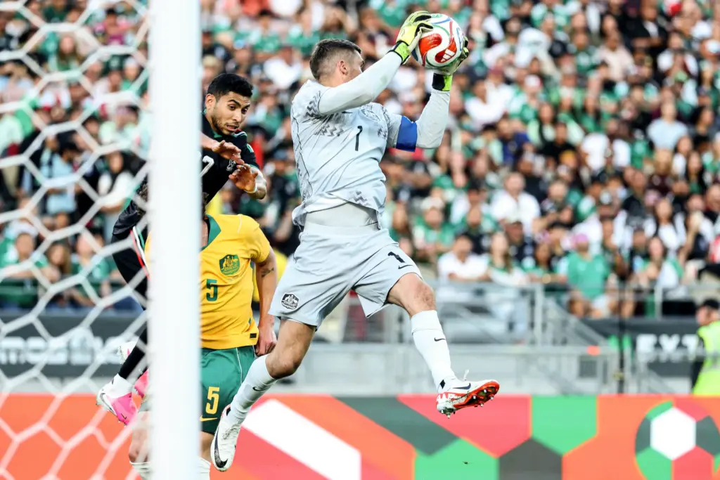 Australia goalkeeper Mathew Ryan, top, makes a save against Mexico...