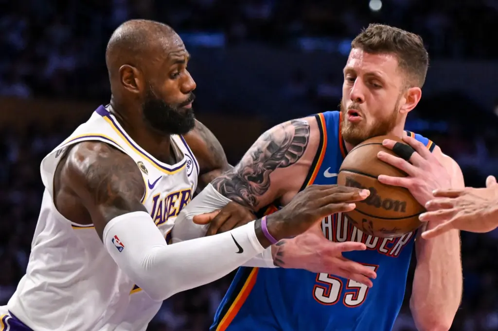 Lakers star LeBron James, left, defends against Oklahoma City Thunder...