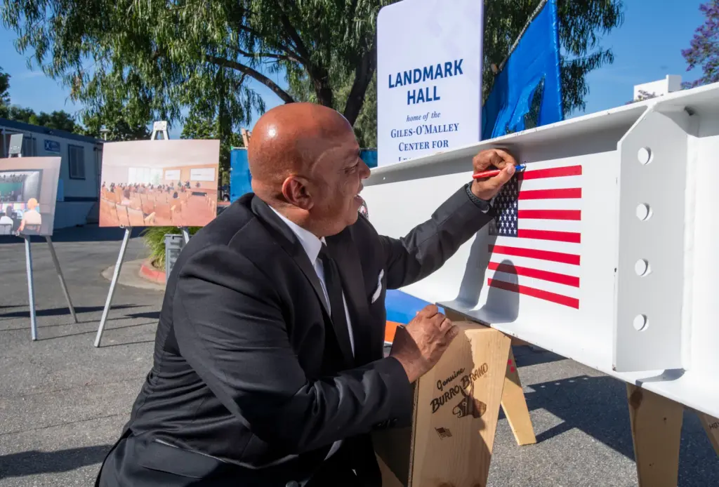 Ronald Rochon, Cal State Fullerton president signs his name on...