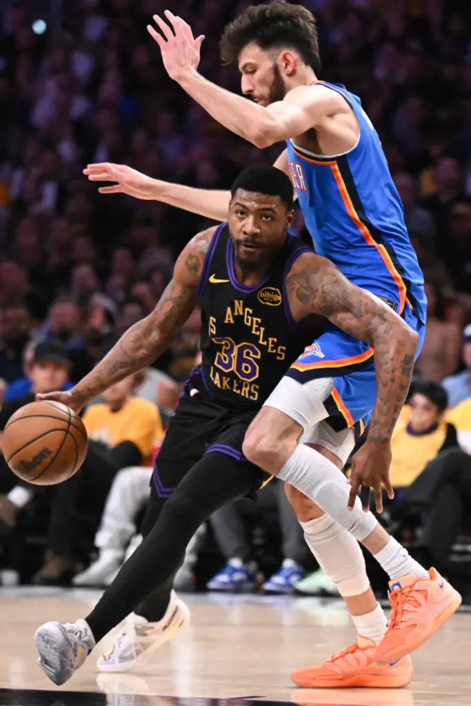 Lakers guard Marcus Smart, left, drives as Oklahoma City Thunder...