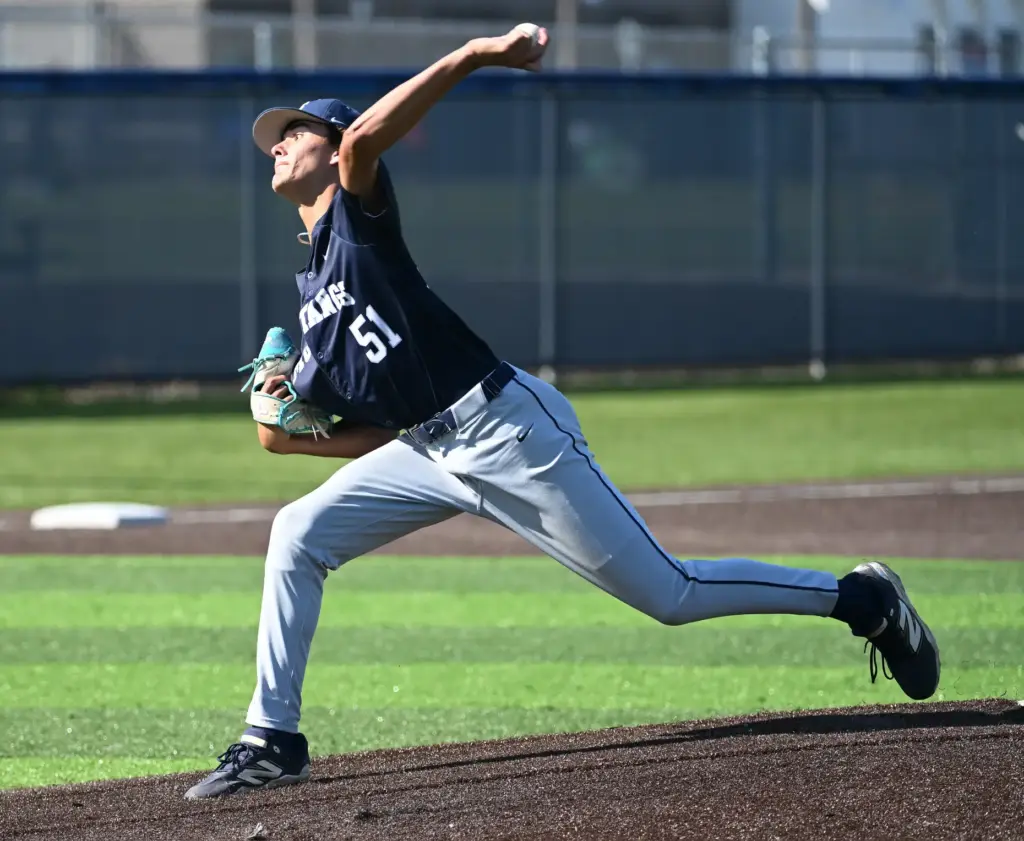 Ethan Miller (51) of Trabuco Hills pitches against Newport Harbor...