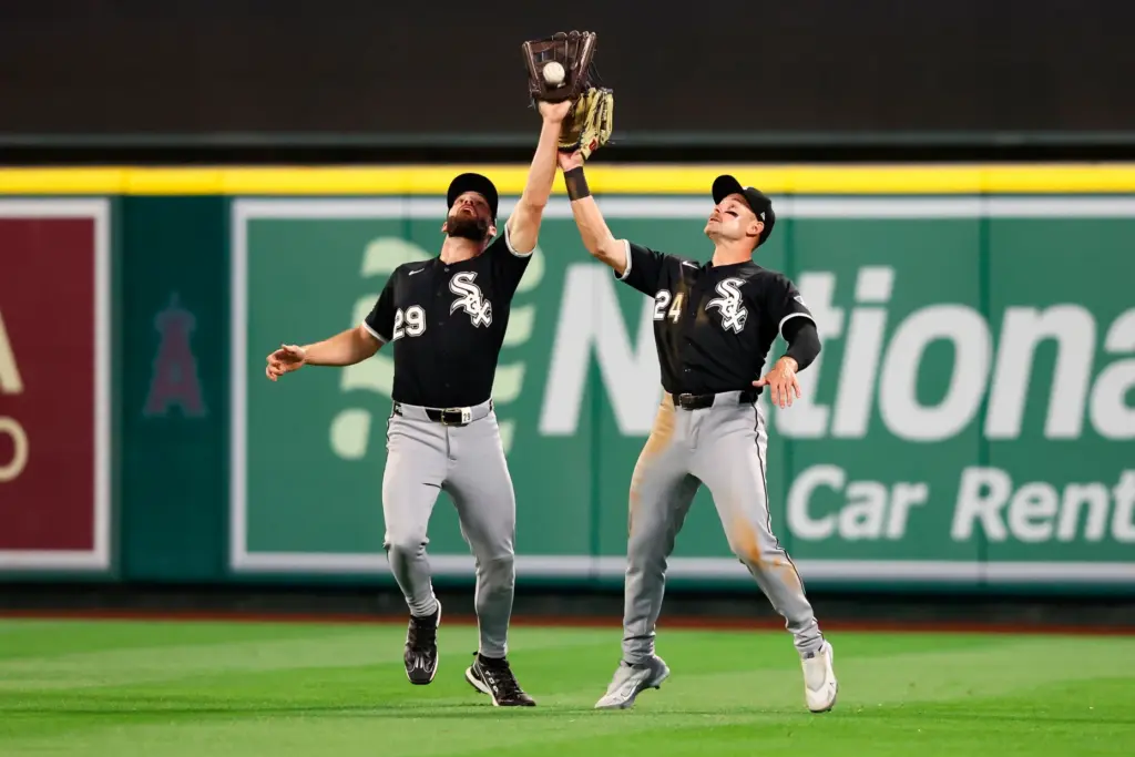 Chicago White Sox center fielder Tristan Peters, left, catches the...