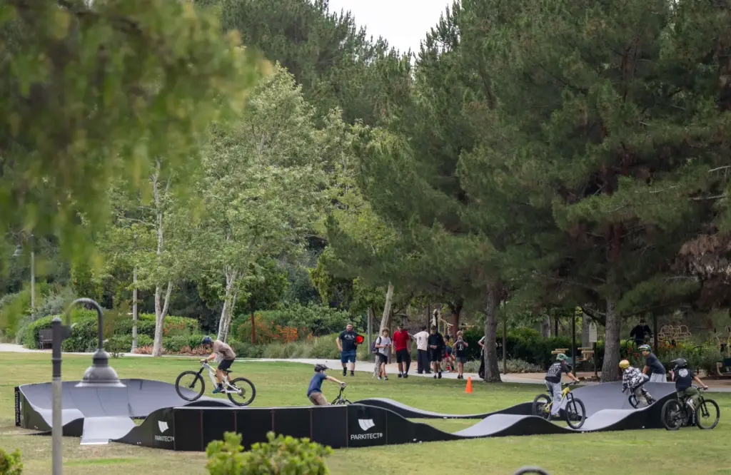A group of friends create a train of bikes as...