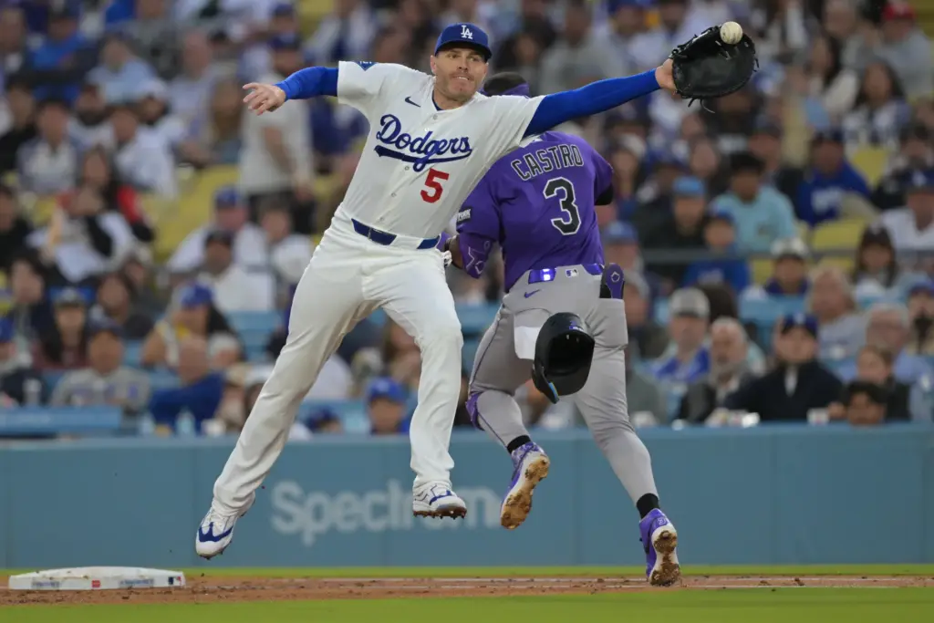 Dodgers first baseman Freddie Freeman, right, is pulled off the...