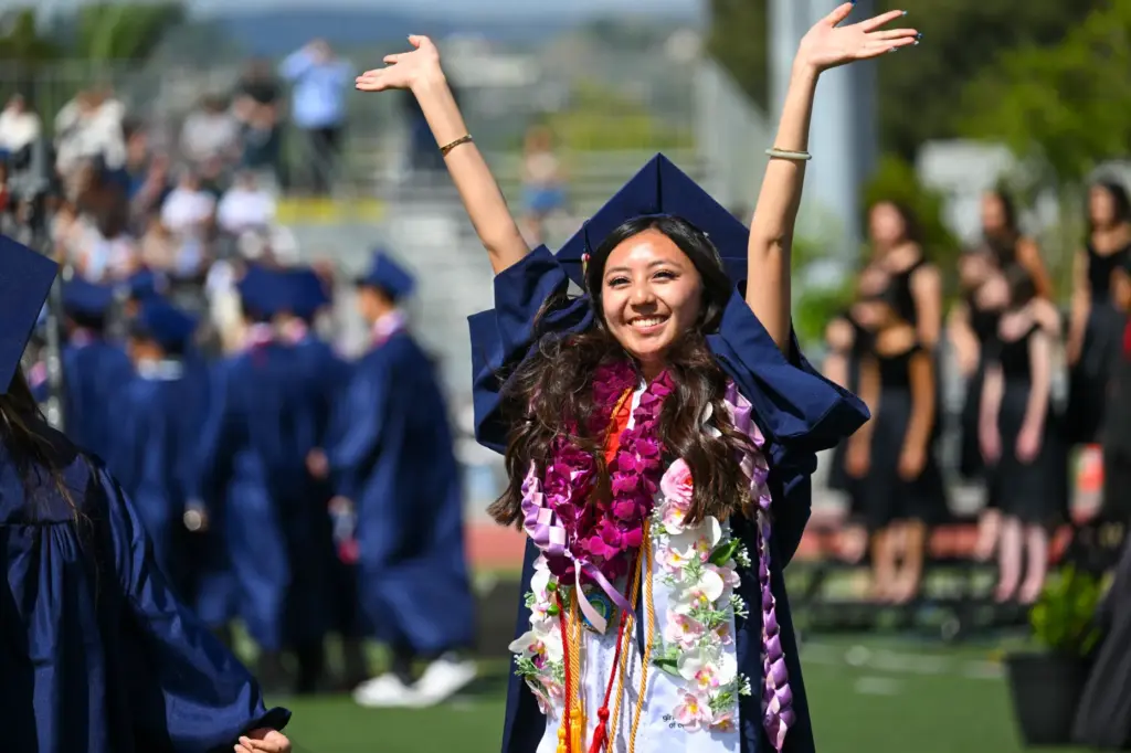 Sophia Chu waves to family and friends during the commencement...