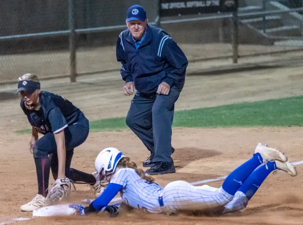 La Mirada shortstop Reese Hilliard slides safely into third base,...