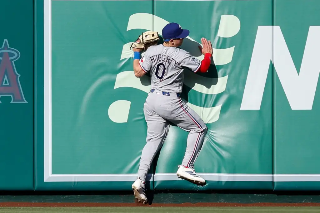 Texas Rangers center fielder Sam Haggerty catches a fly ball...