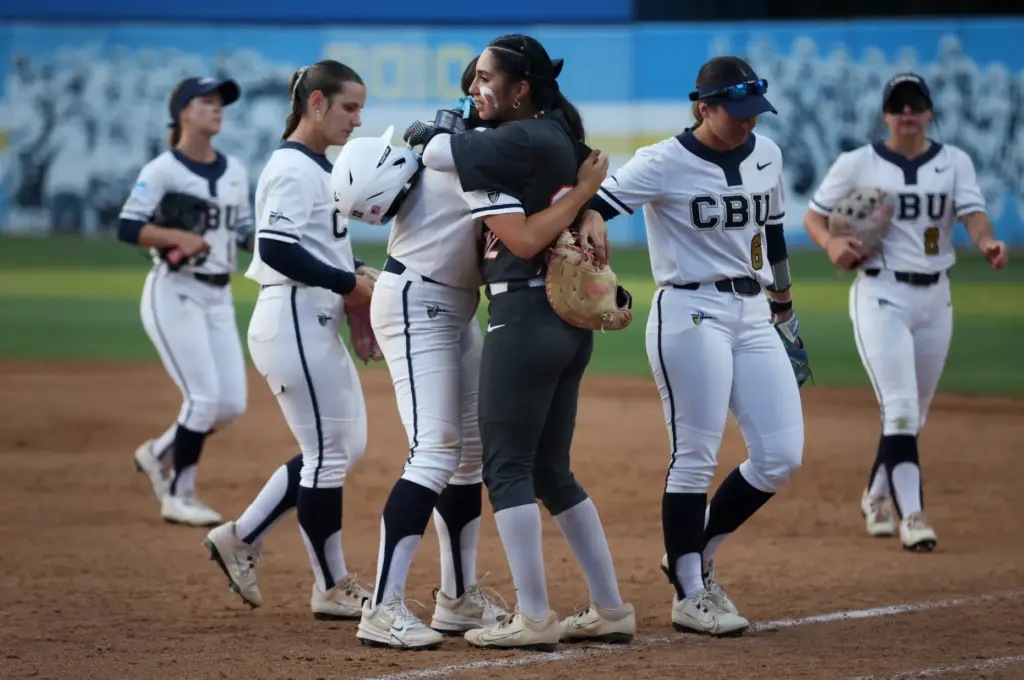 Cal State Fullertonâs Alexia Lopez, center right, embraces Ashlee Annett,...