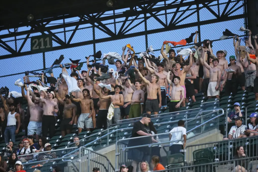 Fans cheer with their shirts off during the seventh inning...