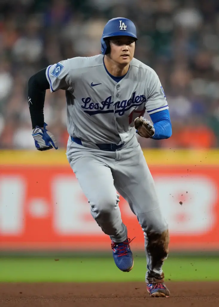 Dodgers star Shohei Ohtani runs to third during the fourth...