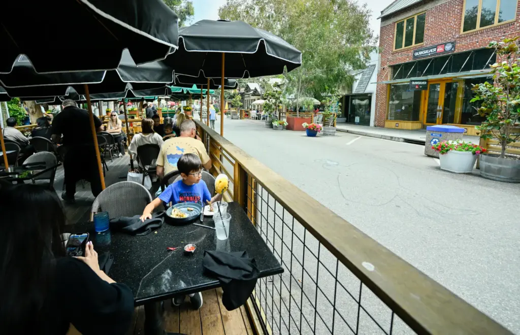 Benjamin Nguyen eats lunch with his mother along Forest Avenue...