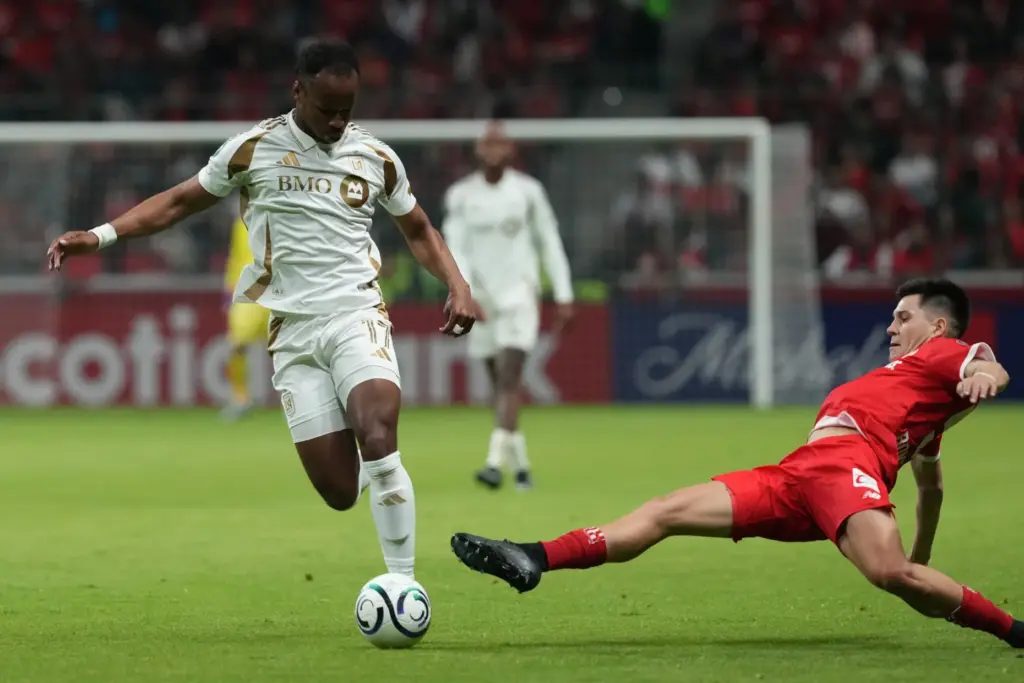Toluca FC’s Pavel Perez, right, challenges LAFC’s Jeremy Ebobisse for...