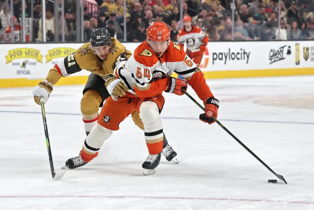 The Ducks’ Mikael Granlund, right, skates with the puck as...