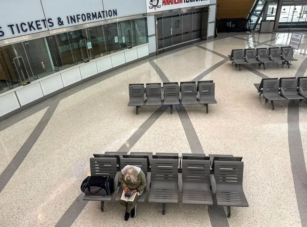 A person waits in the ticketing area at ARTIC in...