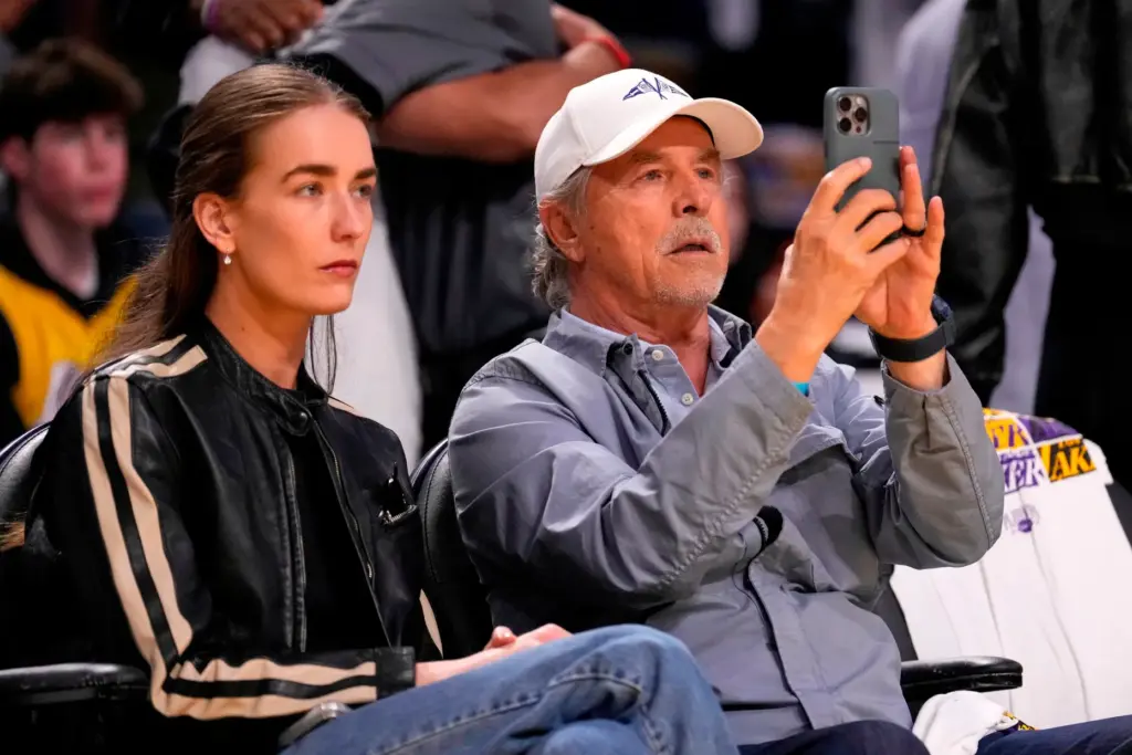 Actor Don Johnson watches with his daughter Grace during the...