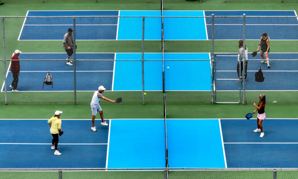 Pickleball players on new courts, the top two courts, along...
