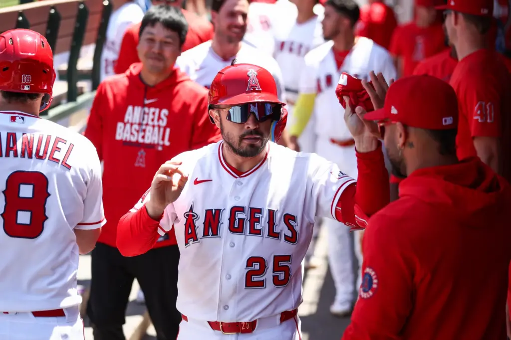 The Angels’ Travis D’Arnaud celebrates with teammates in the dugout...