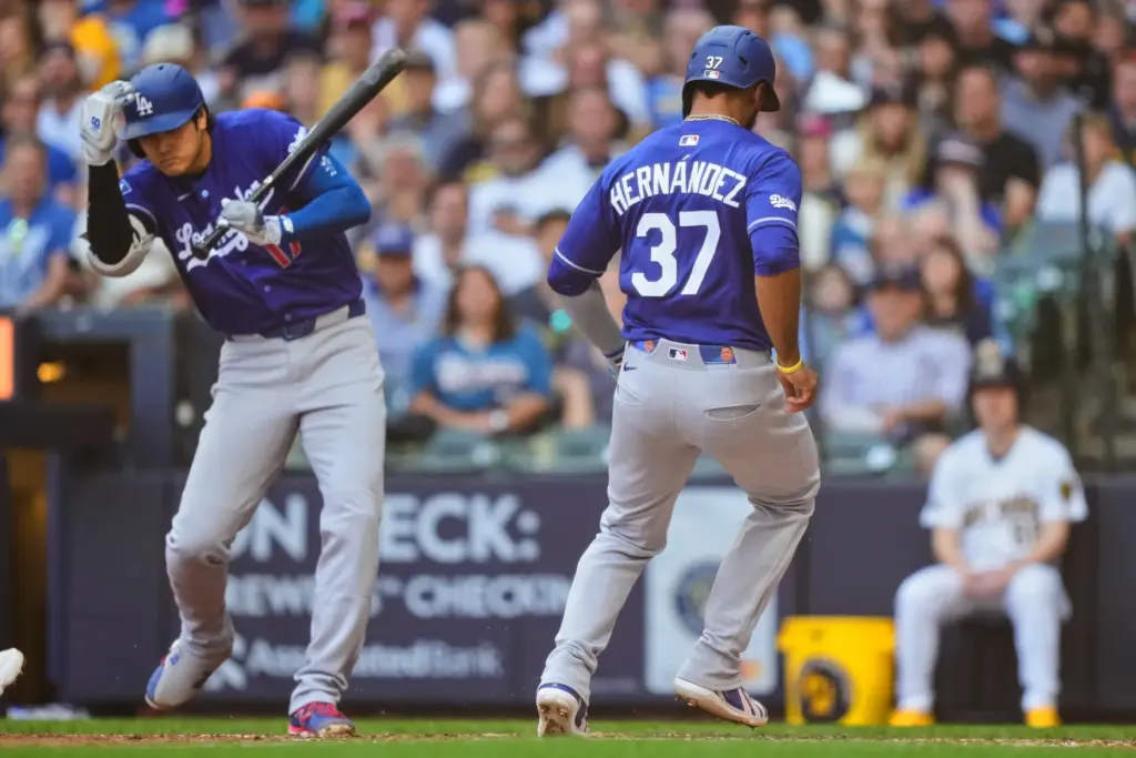 Dodgers’ Teoscar HernÃ¡ndez (37) scores on a wild pitch as...