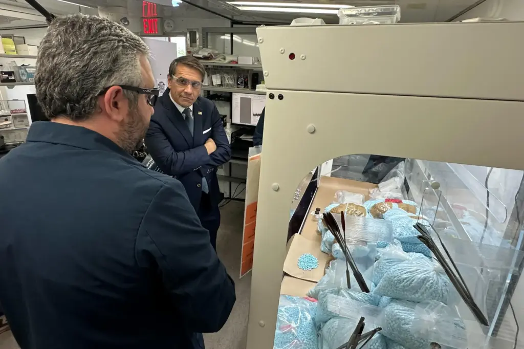 Acting Attorney General Todd Blanche talks to a technician in a Drug Enforcement Administration mobile lab.