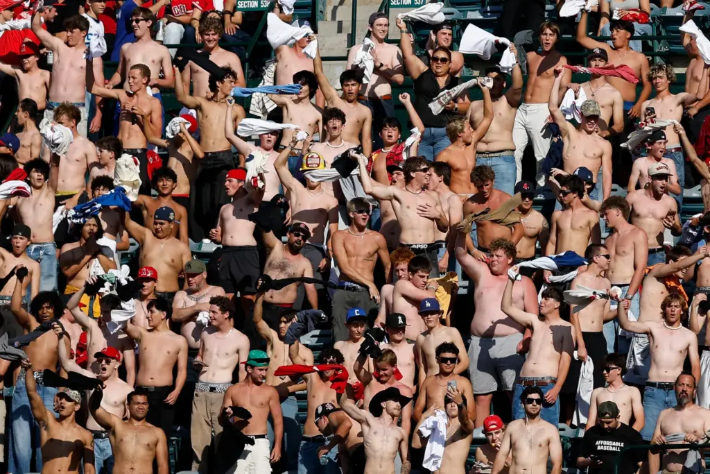 Fans go “tarps off” during the fifth inning of a...