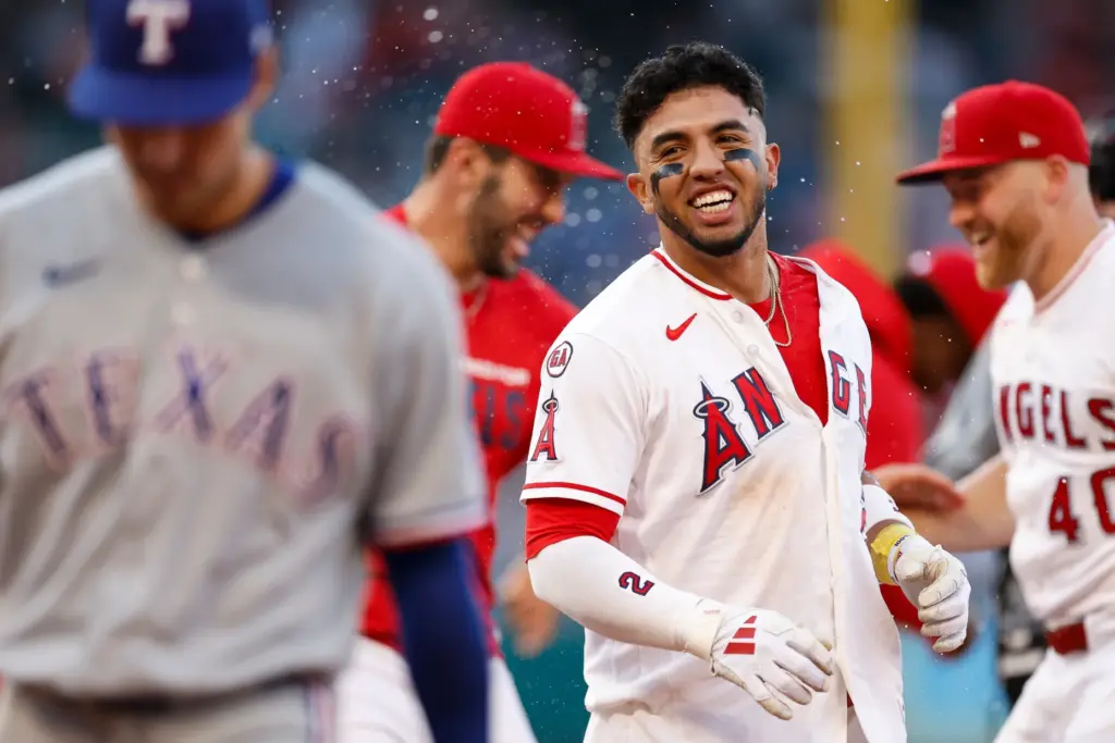 The Angels’ Oswald Peraza (2) is greeted by teammates after...