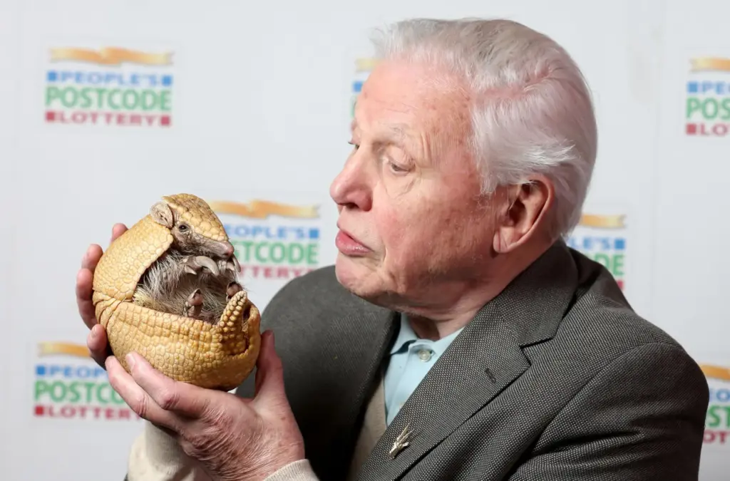 FILE – David Attenborough holds ‘Inti’, an armadillo from Edinburgh...