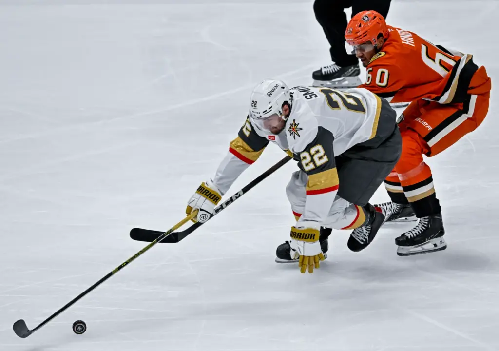 The Vegas Golden Knightsâ Cole Smith, left, controls the puck...