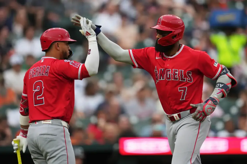 The Angels’ Jo Adell, right, celebrates with teammate Oswald Peraza...
