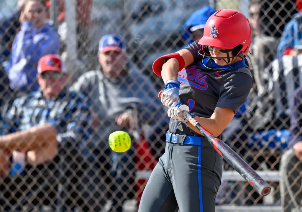 Los Alamitos shortstop Aspen Natori hits the ball during a...