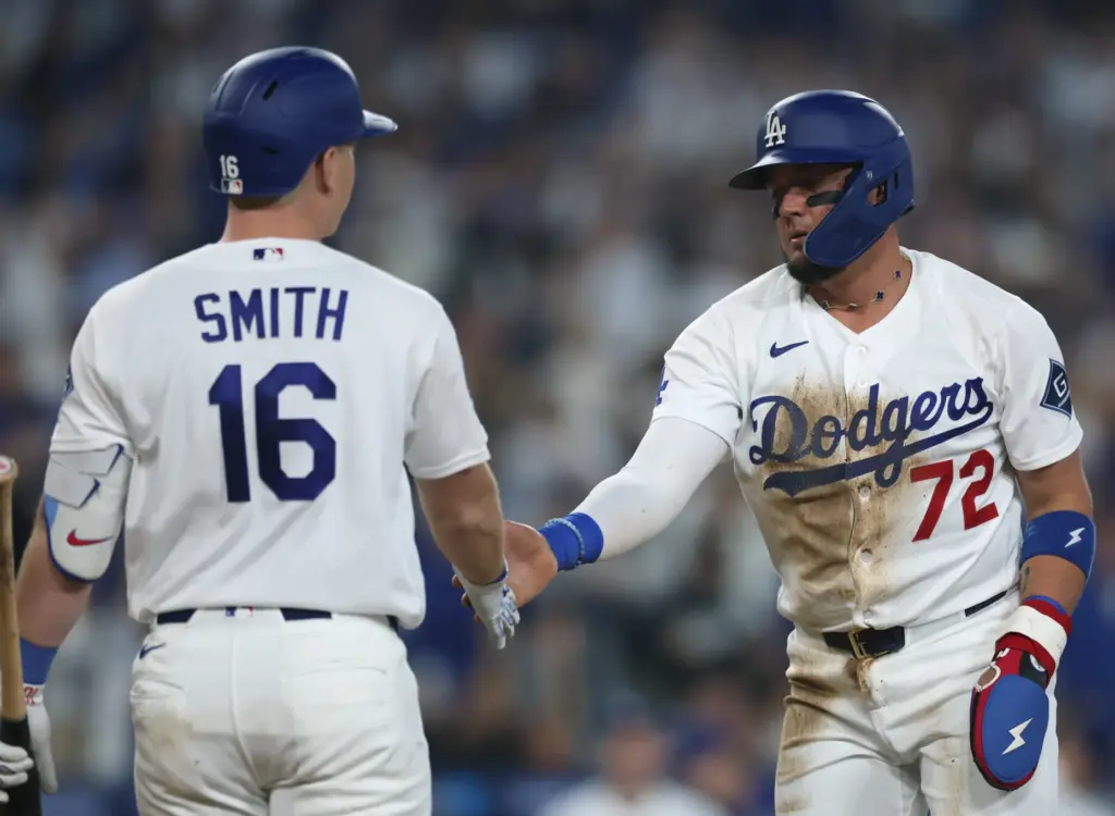 The Dodgers’ Miguel Rojas, right, celebrates with Will Smith after...