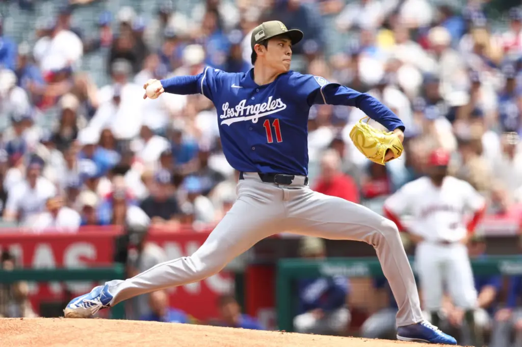 Dodgers pitcher Roki Sasaki (11) throws to a Angels batter...
