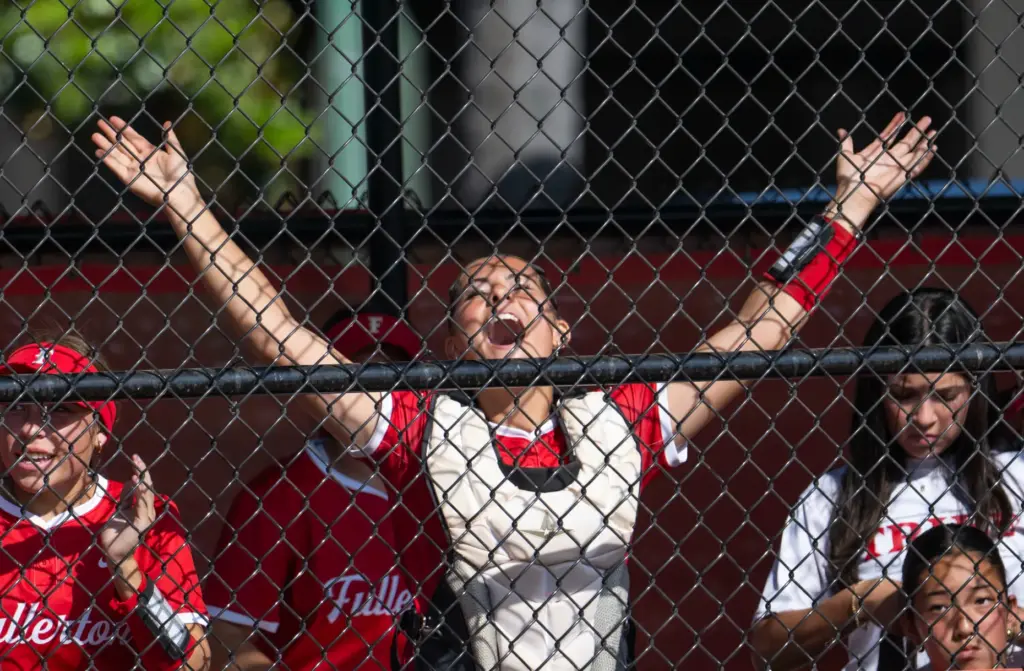 Fullerton catcher Kaylee Mathews cheers on her team as they...