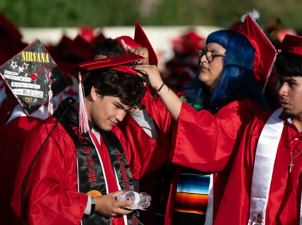 Alexsys Corrales adjusts Mario Cossioâs, left, cap before the start...