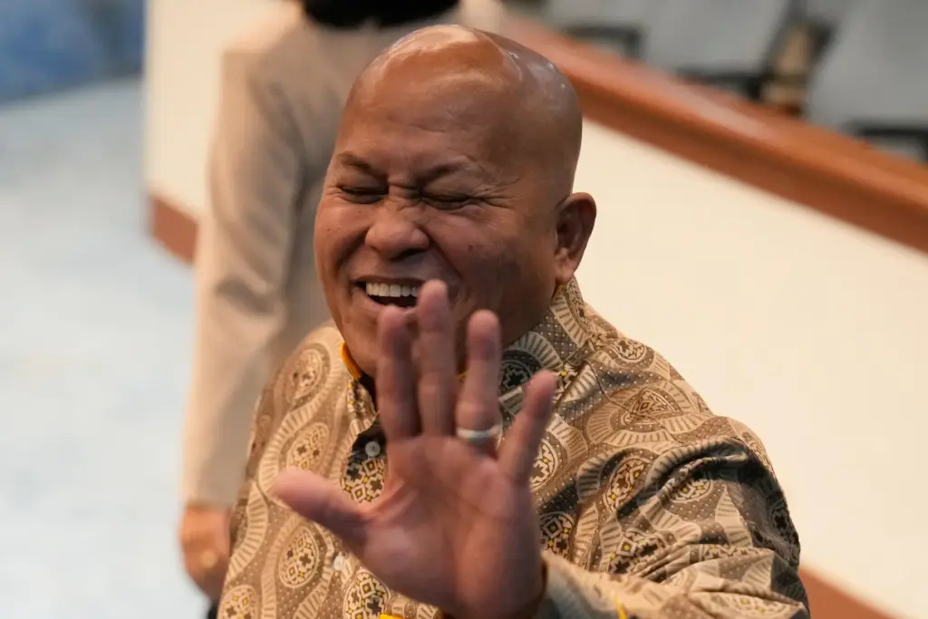 Philippine Senator Ronald dela Rosa gestures to reporters at the...